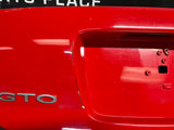 04-06 PONTIAC GTO LICENSE PLATE TRUNK FILLER PANEL TORRID RED OEM #1438