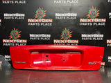 04-06 PONTIAC GTO LICENSE PLATE TRUNK FILLER PANEL TORRID RED OEM #1522
