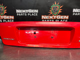 04-06 PONTIAC GTO LICENSE PLATE TRUNK FILLER PANEL TORRID RED OEM #1522