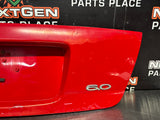 04-06 PONTIAC GTO LICENSE PLATE TRUNK FILLER PANEL TORRID RED OEM #1522