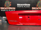 04-06 PONTIAC GTO LICENSE PLATE TRUNK FILLER PANEL TORRID RED OEM #1522